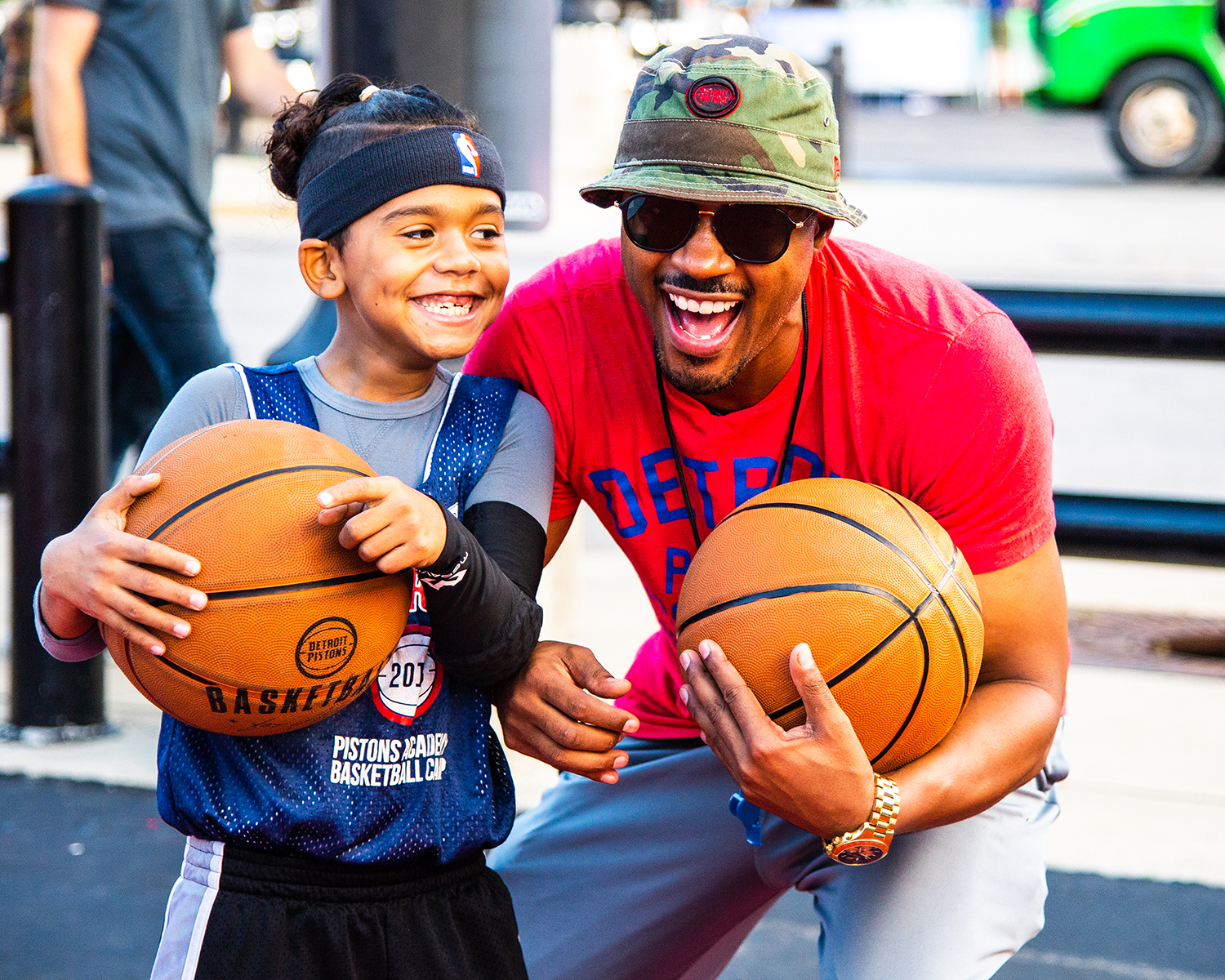 A basketball coach poses with a young fan.